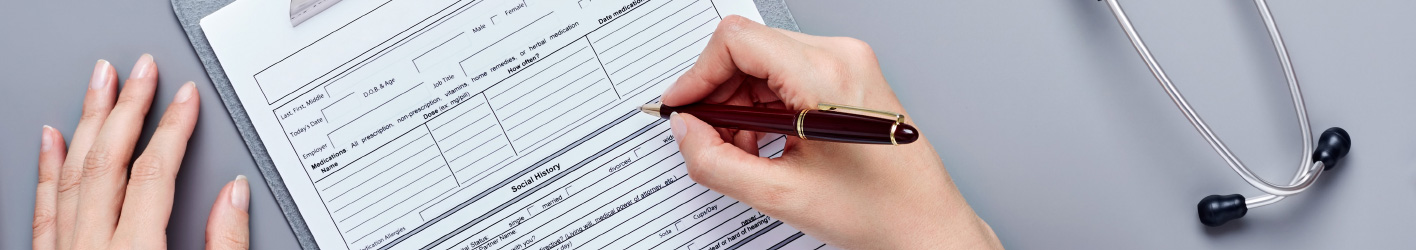 Person filling in a form using a pen