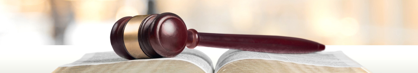 Gavel laying on top of a book