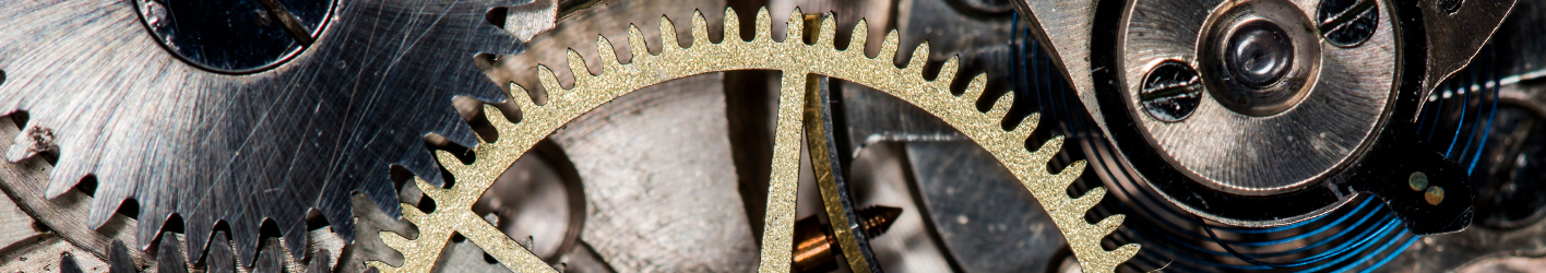 Picture of gears working together. One is gold colored.