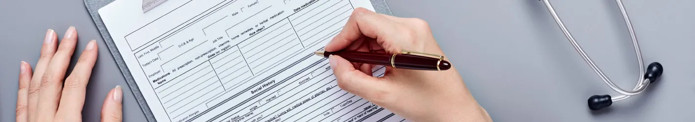Person filling in a form using a pen