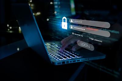 Person typing on laptop with a lock graphic and username password login graphic