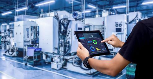 Man holding tablet inspecting a data center