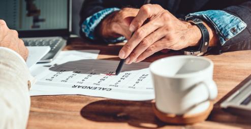 Individual writing on a calendar