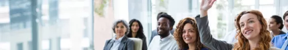 Woman raising hand to ask question